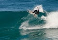 A male surfer executing a backside top-turn off-the-lip at Iluka`s North Wall. Royalty Free Stock Photo