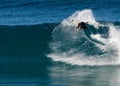A male surfer executing a backside top-turn off-the-lip at Iluka`s North Wall. Royalty Free Stock Photo