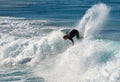 A male surfer forces a backside top-turn, as a small wave closes out, at Iluka`s North Wall. Royalty Free Stock Photo