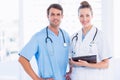 Male surgeon and female doctor with medical reports