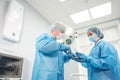 Male surgeon holding syringe isolated on a white background. Focus on syringe Royalty Free Stock Photo