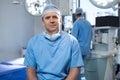 Male surgeon sitting in operation theater Royalty Free Stock Photo