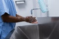 Male surgeon washing hands in sink at hospital Royalty Free Stock Photo