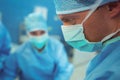 Male surgeon wearing surgical mask in operation theater Royalty Free Stock Photo