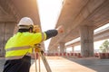 A male surveyor engineers worker making measuring and pointing finger with theodolite on road works. Survey engineer at road Royalty Free Stock Photo