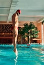 A male swimmer dives into the pool with his head into the water, the start of the swim in the pool. Royalty Free Stock Photo