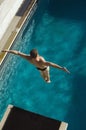 Male Swimmer Jumping From Springboard