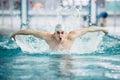 Male swimmer, performing the butterfly stroke technique at indoor pool. vintage effect Royalty Free Stock Photo