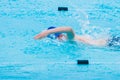 male swimmer swimming freestyle stroke in swimming pool