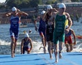 Male swimmers climbing up from the water Royalty Free Stock Photo