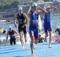 Male swimmers climbing up from the water Royalty Free Stock Photo