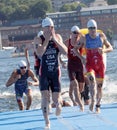 Male swimmers climbing up from the water Royalty Free Stock Photo