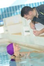 male swimming coach with female swimer