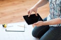 Male with tablet pc, blueprint and measuring tape