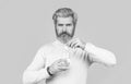 Male taking a pill with a glass of water. Man take some pills, holds glass of water, isolated on blue. Black and white