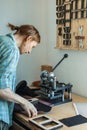 Male tanner working with handpress device machine cutting pattern on stuff material leather workshop Royalty Free Stock Photo