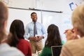 Male teacher in front of students at an adult education class Royalty Free Stock Photo