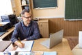 Male teacher having online class through video call and explaining maths. e-learning via interactive platform. Royalty Free Stock Photo