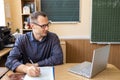 Male teacher having online class through video call and explaining maths. e-learning via interactive platform. Royalty Free Stock Photo