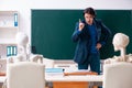 The male teacher and skeleton student in the classroom Royalty Free Stock Photo