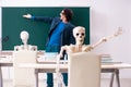 The male teacher and skeleton student in the classroom Royalty Free Stock Photo