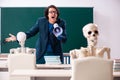 The male teacher and skeleton student in the classroom Royalty Free Stock Photo