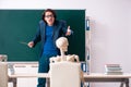 Male teacher and skeleton student in the classroom Royalty Free Stock Photo