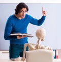 Male teacher and skeleton student in the classroom Royalty Free Stock Photo