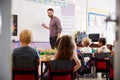 Male Teacher Standing At Whiteboard Teaching Maths Lesson To Elementary Pupils In School Classroom Royalty Free Stock Photo