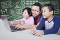 Male teacher teach two students with laptop Royalty Free Stock Photo