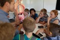 Male teacher using an human anatomy model to teach
