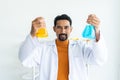 Male teacher in white lab coat with safety goggles with background laboratory tools in primary school science classroom Royalty Free Stock Photo