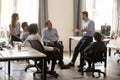 Male team leader talking to diverse businesspeople at office mee Royalty Free Stock Photo