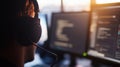 male tech professional wearing headset while coding on screens in subdued office lighting background concept of software Royalty Free Stock Photo