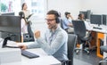 Male technical support operator with headset working in call center. Royalty Free Stock Photo