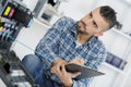 Male technician assessing photocopier Royalty Free Stock Photo