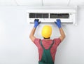 Male technician checking air conditioner Royalty Free Stock Photo