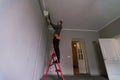 Male technician cleaning air conditioner indoors