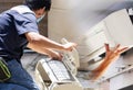 Male technician cleaning air conditioner indoors, Repairman washing dirty compartments air conditioner, Maintenance and repairing Royalty Free Stock Photo