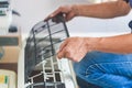 Male technician cleaning air conditioner indoors, Repairman washing dirty compartments air conditioner, Maintenance and repairing Royalty Free Stock Photo