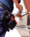 Male technician connects outdoor air conditioning unit to wall of old apartment building. Royalty Free Stock Photo