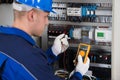 Male Technician Examining Fusebox