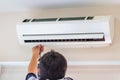 Male technician fixing air conditioner indoors, Repairman washing dirty compartments air conditioner, Maintenance and repairing