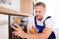 Male Technician Fixing Dishwasher Royalty Free Stock Photo