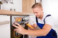 Male Technician Fixing Dishwasher Royalty Free Stock Photo