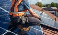 Male technician installing photovoltaic blue solar panel on a rooftop Royalty Free Stock Photo