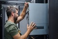 Technician installing server hardware in a data center rack performing IT maintenance and equipment upgrade Royalty Free Stock Photo