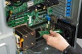 Male IT technician installs RAM module in server during hardware upgrade and maintenance Royalty Free Stock Photo