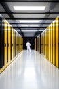 Male technician in modern data center with yellow server cabinets Royalty Free Stock Photo