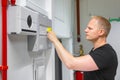 Male Technician Opening Fire Panel In Data Center